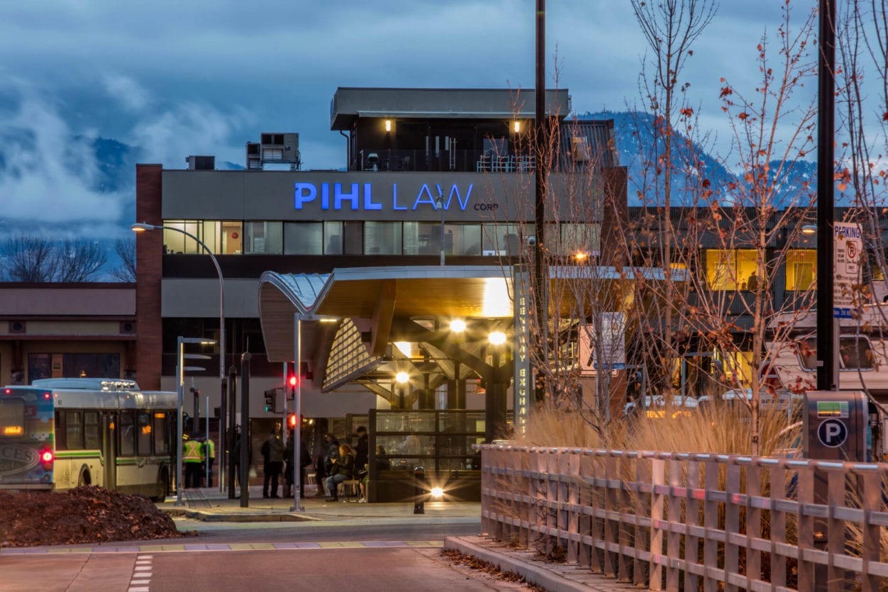 Pihl Law Office Building from Queensway Bus Station at dusk with light flare