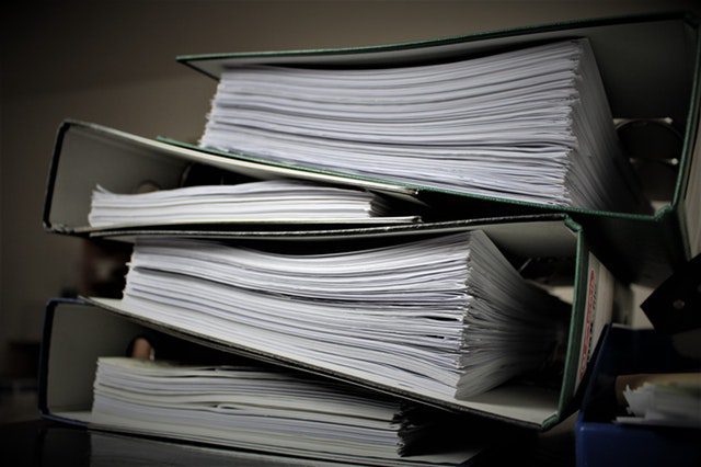 Stack of Binders highlighting the litigation process