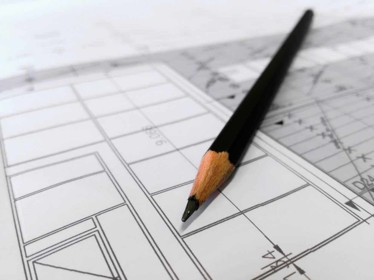 Closeup of a pencil on a construction drawing highlighting builder's lien