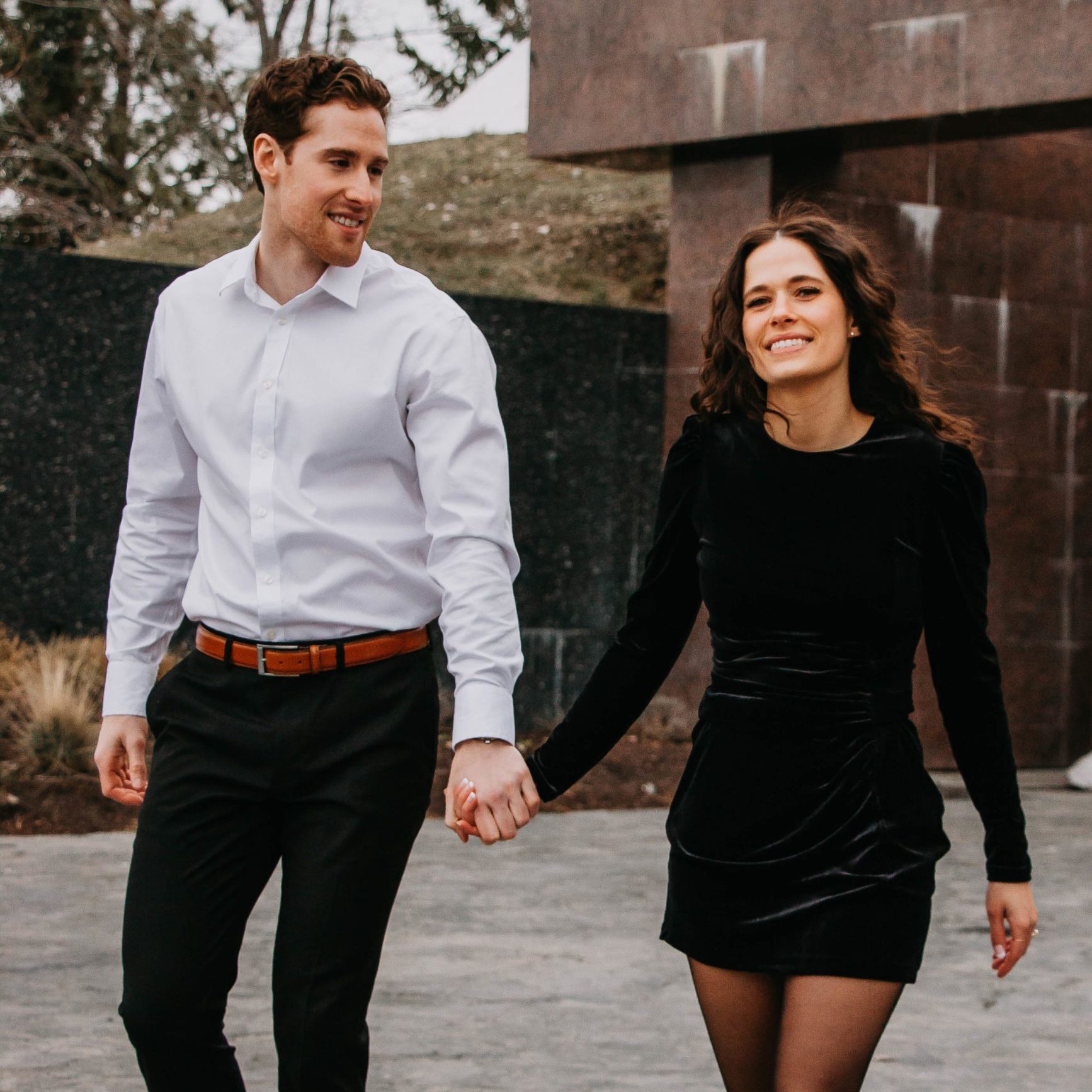 couple holding hands walking